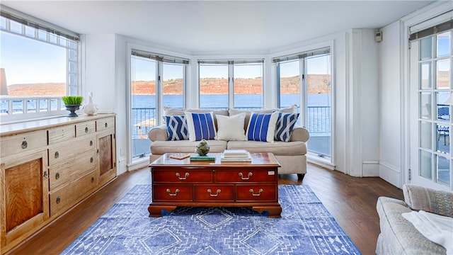 sunroom / solarium featuring a water view