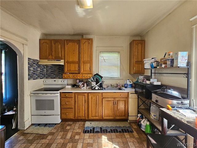 kitchen featuring dark tile floors, sink, white appliances, tasteful backsplash, and crown molding