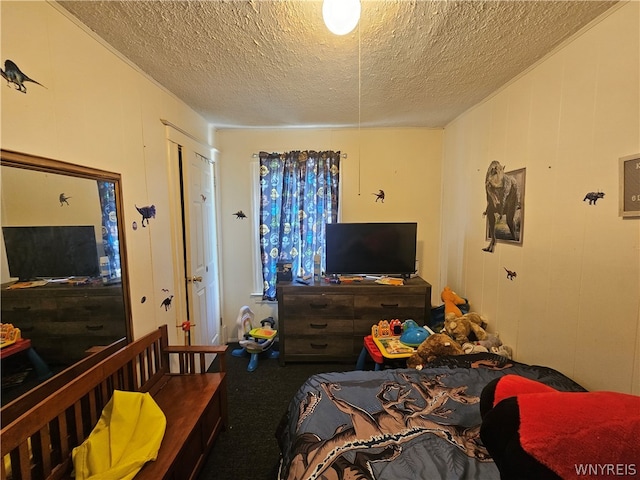 carpeted bedroom featuring a textured ceiling