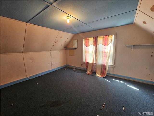 bonus room featuring lofted ceiling and carpet flooring