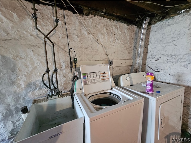 clothes washing area with washing machine and clothes dryer