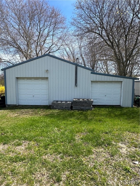 garage featuring a lawn