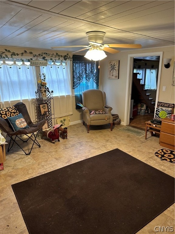 unfurnished living room featuring plenty of natural light, ceiling fan, and tile floors