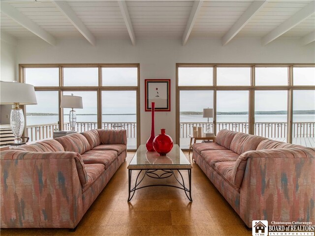 2 Elm Ln, Chautauqua, NY 14722 - living area with tile patterned floors, beamed ceiling, a healthy amount of sunlight, and a water view
