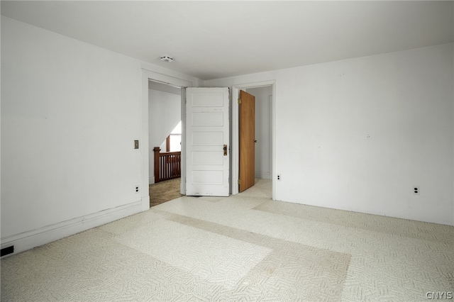 spare room featuring light colored carpet