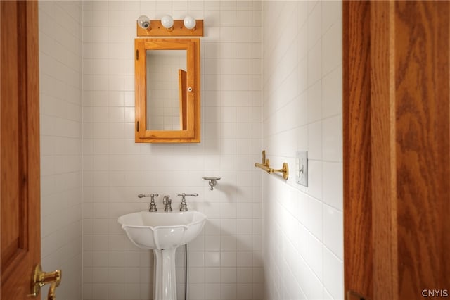 bathroom with tile walls