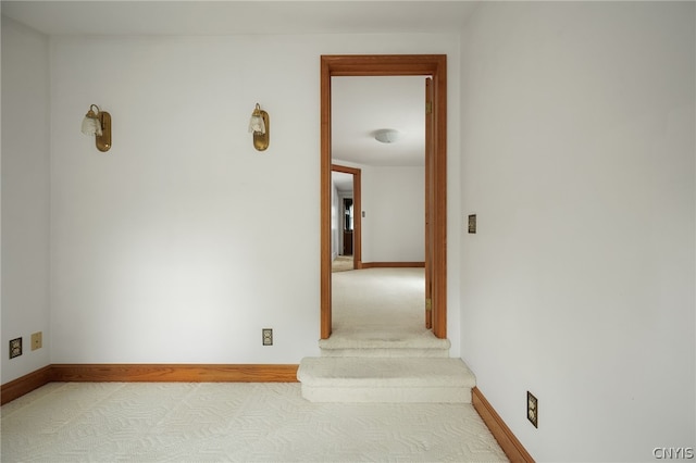 hallway featuring light carpet