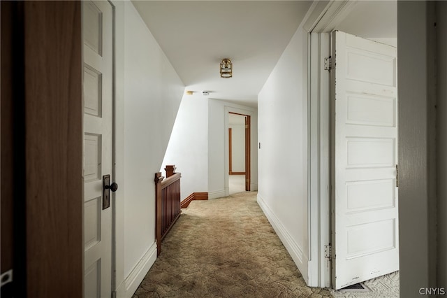 hallway with light colored carpet