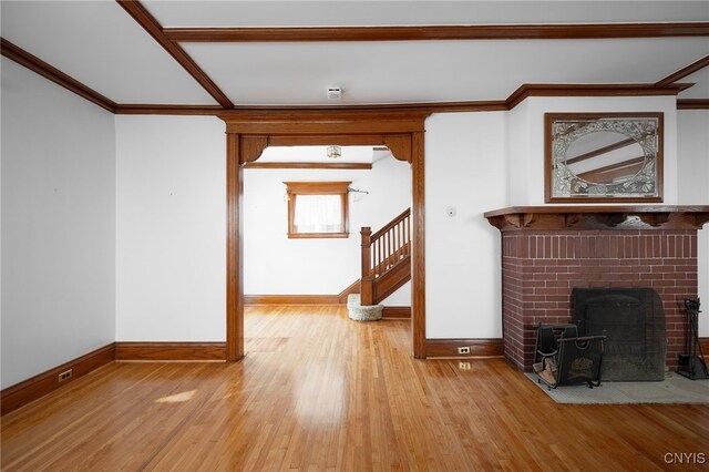 unfurnished living room with ornamental molding and light hardwood / wood-style floors