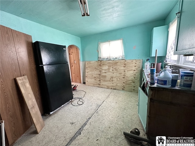 kitchen featuring black fridge