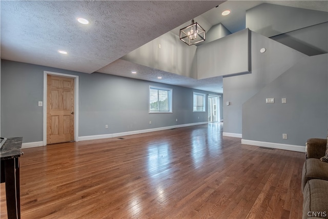 living room with hardwood / wood-style flooring and a textured ceiling