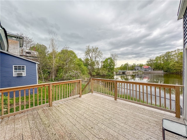 wooden terrace featuring a water view