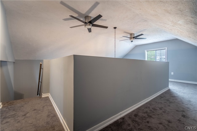 additional living space featuring a textured ceiling, lofted ceiling, carpet floors, and ceiling fan