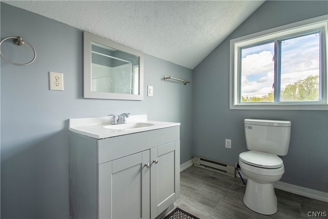 bathroom with toilet, a baseboard heating unit, large vanity, a textured ceiling, and lofted ceiling