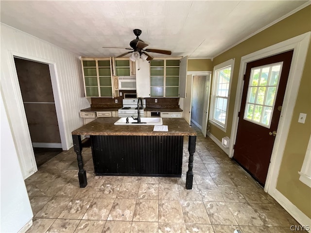 interior space featuring a center island with sink, white appliances, a breakfast bar, ceiling fan, and light tile floors