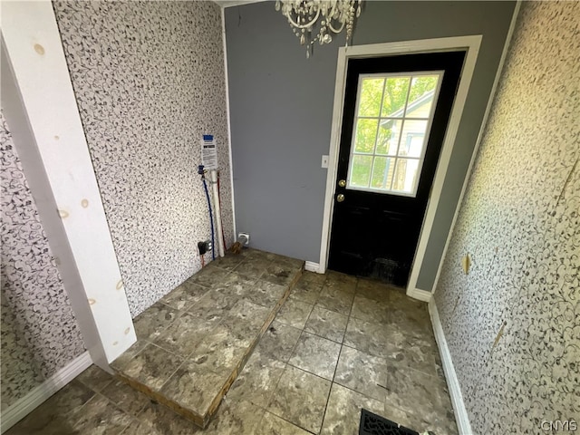 doorway featuring tile flooring and a chandelier