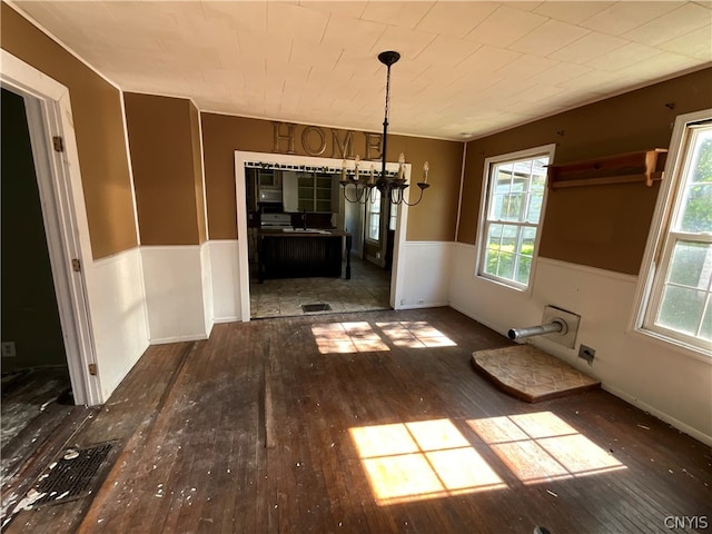 unfurnished dining area featuring tile floors and an inviting chandelier