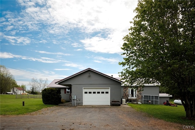 view of front of property featuring a front yard and a garage