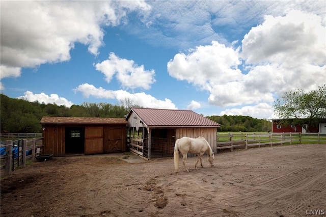 view of stable featuring a rural view