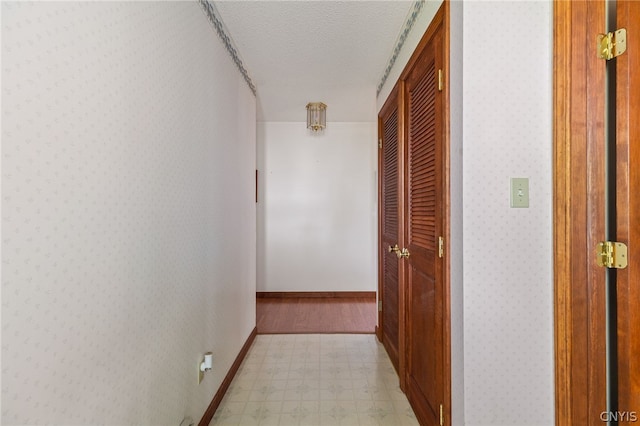 hallway featuring a textured ceiling