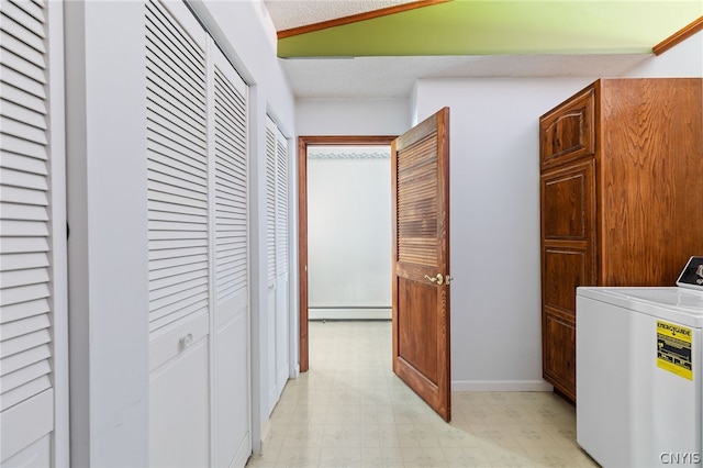 laundry area featuring cabinets, baseboard heating, and washer / dryer