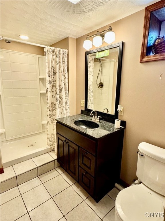 bathroom featuring vanity, walk in shower, a textured ceiling, toilet, and tile patterned floors