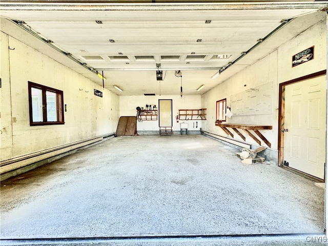 garage featuring a garage door opener and a baseboard radiator