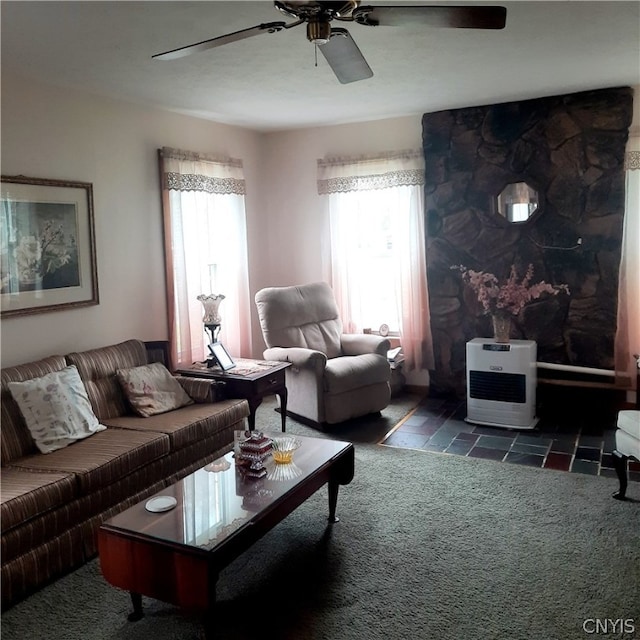 living room featuring dark carpet and ceiling fan