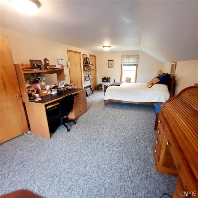 bedroom featuring vaulted ceiling and light carpet