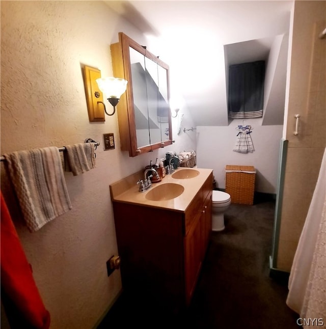 bathroom featuring vanity, curtained shower, and toilet