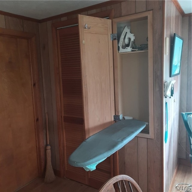 bathroom with hardwood / wood-style floors and wood walls