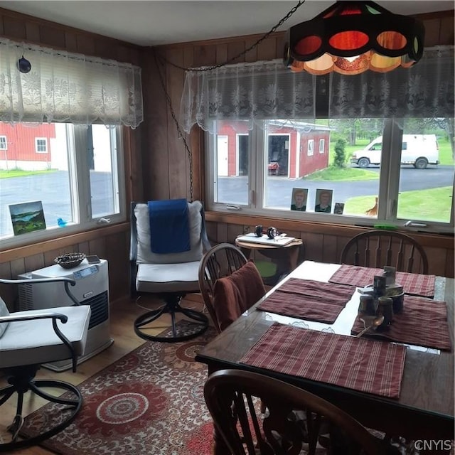 dining room featuring wooden walls and wood finished floors