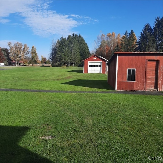 view of yard with an outdoor structure and a garage