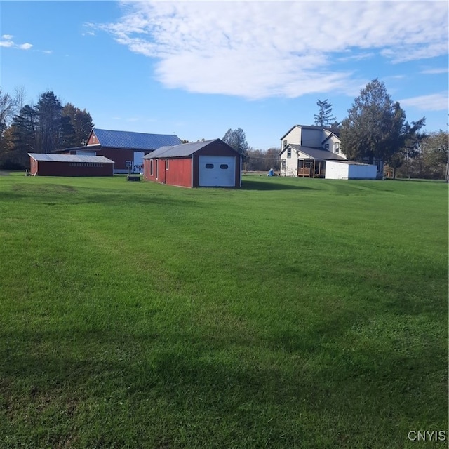 view of yard with a garage and an outdoor structure