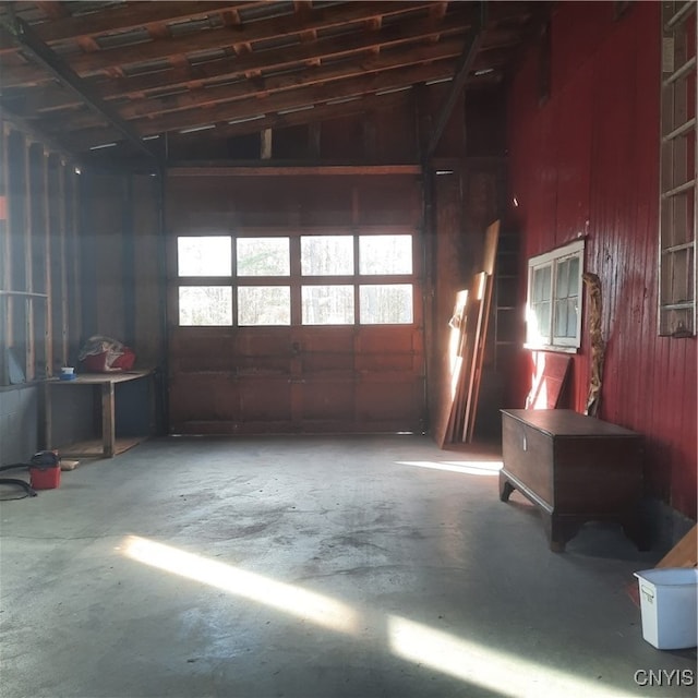 miscellaneous room featuring vaulted ceiling and concrete floors