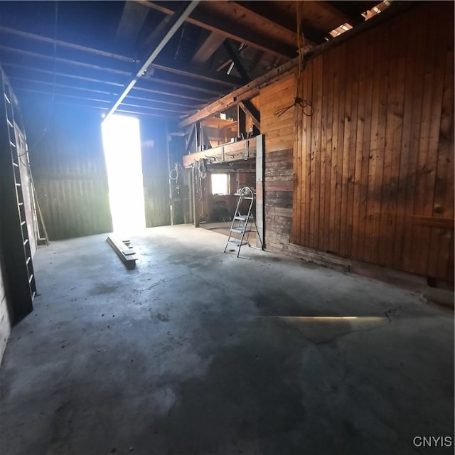 basement featuring wood walls