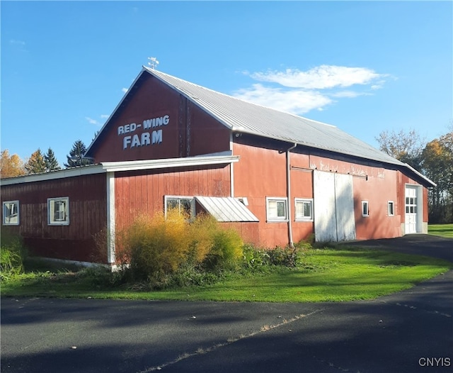 view of side of property with a lawn