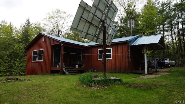 rear view of property featuring a lawn