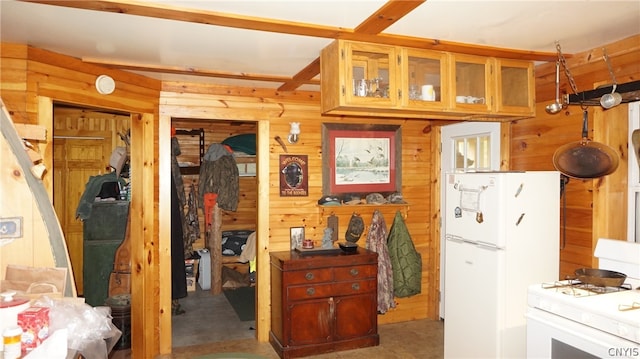 kitchen with white appliances and wooden walls