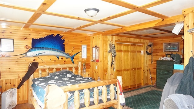 bedroom with coffered ceiling, a closet, and wood walls