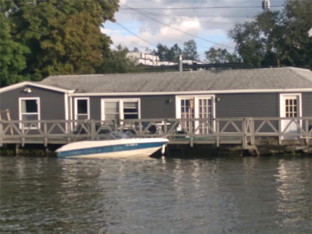 view of dock with a deck with water view