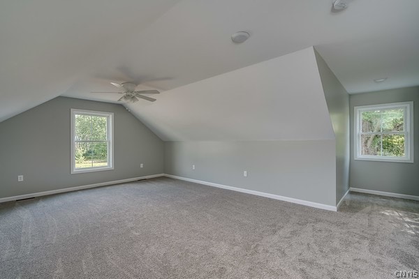 additional living space featuring carpet, ceiling fan, and lofted ceiling