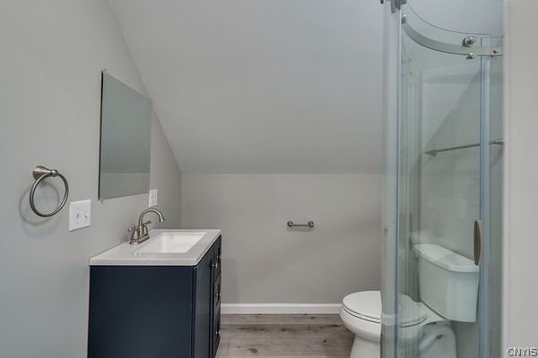 22217 Freedom Dr, Champion, NY 13619 - bathroom with hardwood / wood-style flooring, toilet, an enclosed shower, vanity, and lofted ceiling