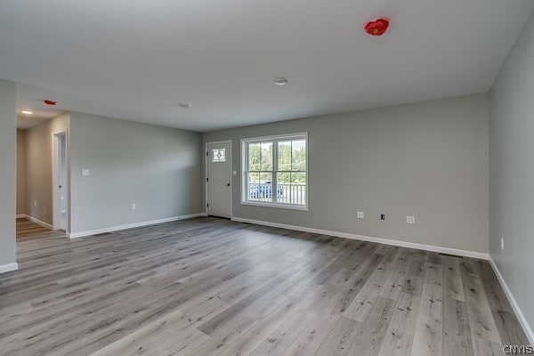 unfurnished room with light hardwood / wood-style flooring