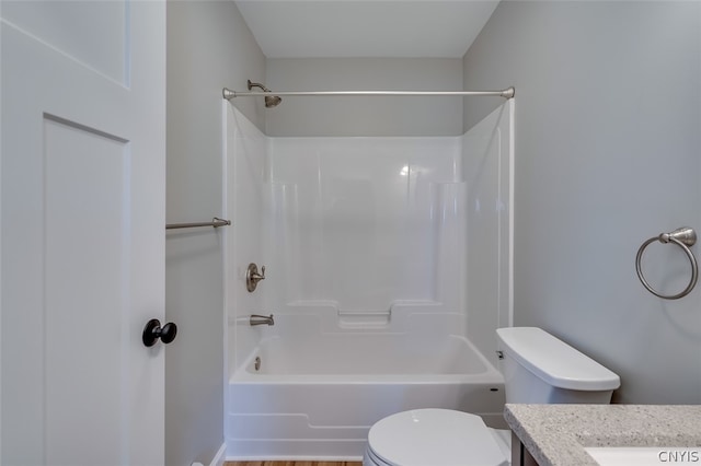 full bathroom with bathing tub / shower combination, vanity, and toilet