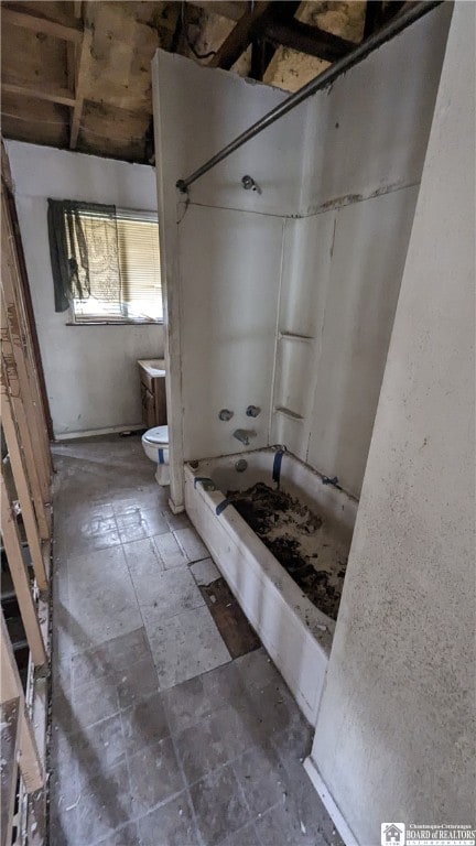 bathroom featuring tile flooring and toilet