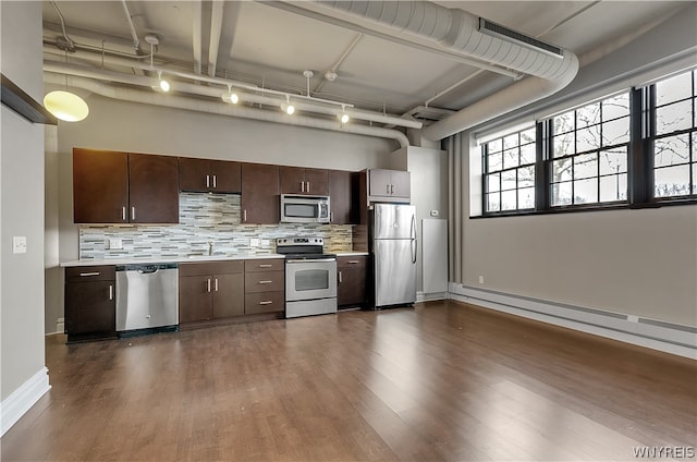 kitchen with dark hardwood / wood-style flooring, stainless steel appliances, tasteful backsplash, rail lighting, and sink