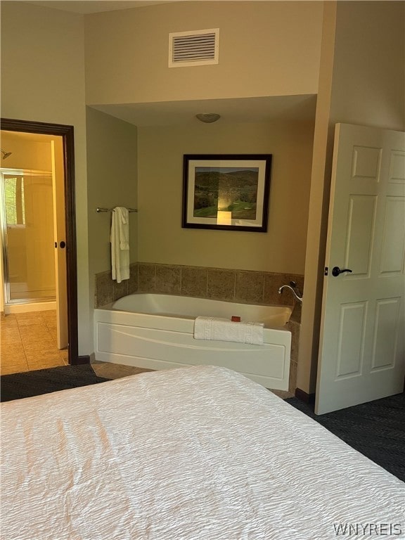 bathroom featuring tile floors and independent shower and bath