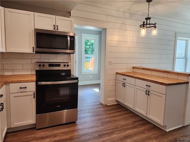 kitchen with white cabinetry, hanging light fixtures, dark wood-type flooring, appliances with stainless steel finishes, and wooden counters