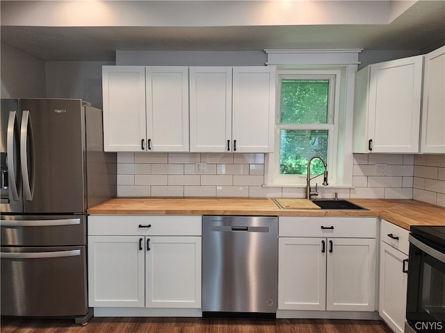 kitchen featuring dark hardwood / wood-style floors, sink, tasteful backsplash, and appliances with stainless steel finishes